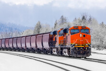 Winter Scene Of A Locomotive Pulling A Freight Train Close To Whitefish, Montana With Exhaust Poring Out Of The Engine On A Cold Day In January