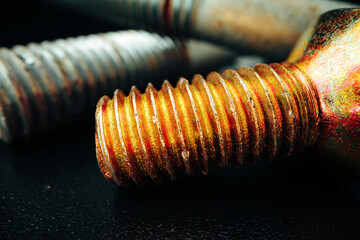 Iron screw bolts on black background close up