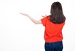 back rear view young woman brunette pointing aside looking blank side copy space