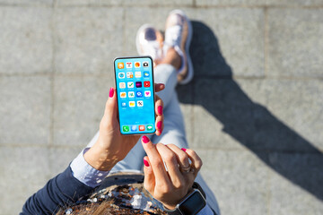 woman using mobile phone, home screen mockup with app icons