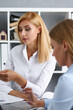 © H_Ko - Group of people deliberate on white laptop problem in office portrait. Graph consult, idea participate, creative talk, review situation job, client document explain, train, successful decision concept