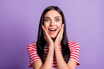 Photo of crazy excited young lady look camera hands cheeks wear striped red shirt isolated purple color background