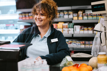 Wall Mural - Supermarket cashier attending customer