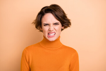 Wall Mural - Portrait of young angry furious stressed unhappy annoyed girl stressed about problem isolated on beige color background