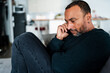 © SYCprod - Depressed mixed race man talking on the phone