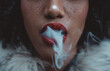 © oneinchpunch - Woman smoking, close up on smoke and mouth