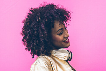 Beautiful latin woman with curly hair, portrait set in the city