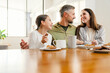 © Drobot Dean - Happy masculine military man hugging his family while having breakfast