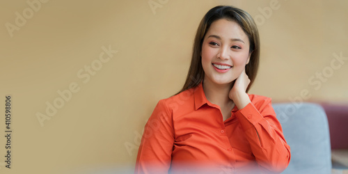 Portrait of young asian woman with smiling face sitting in creative office © Naypong Studio