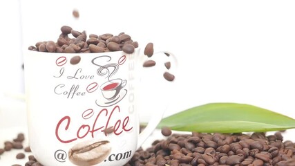 Wall Mural - View of dropping coffee seeds over a glass filled with coffee seeds, View of coffee cups