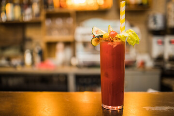 Bloody Mary Cocktail served in bar, garnished with lime, celery and tomato