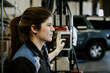 © rawpixel.com - Female mechanic holding a switch in the garage