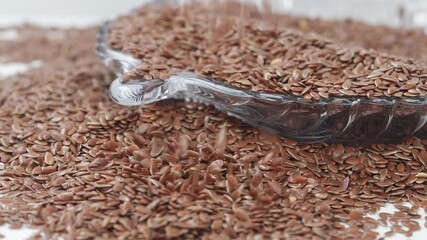 Sticker - View of dropping flax seeds, Close shot of flax seeds falling