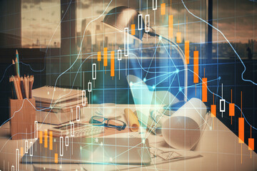 Double exposure of stock market graph drawing and office interior background. Concept of financial analysis.