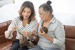 © Bangkok Click Studio - A middle aged daughter tri to teach older senior mother to make a dress with knitting handcraft work. Idea for family love and time sharing