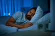 sleeping, insomnia and people concept - sleepless indian man lying in bed at home at night
