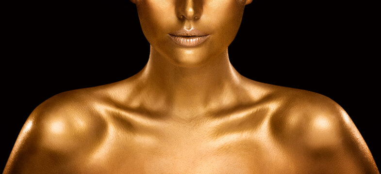 fashion gold skin beauty woman portrait. face model golden makeup. gold lips make up and shiny body 