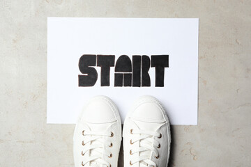 Poster - Sheet of paper with word Start and stylish sneakers on grey table, flat lay