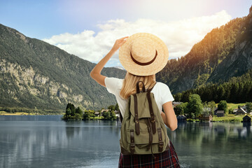 Wall Mural - Tourist with travel backpack enjoying mountain landscape during summer vacation trip