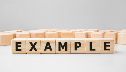 word example made with wood building blocks