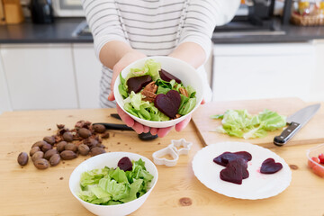 Woman preparing vegetable salad in her kitchen. Healthy Food. Diet.Healthy lifestyle concept.Vegan Salad.Cooking At Home