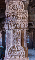 Wall Mural - Bagalakote, Karnataka, India - November 7, 2013: Pattadakal temple complex. Closeup of gray stone pillar with sculpted musicians playing for royal couple, and fighting elephants, Virupaksha temple.