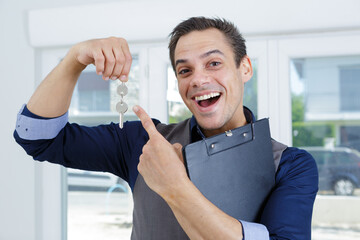 happy sales manager holding house key