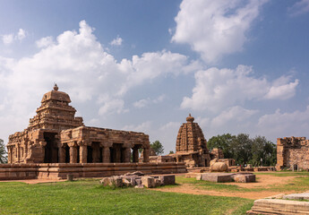 Wall Mural - Bagalakote, Karnataka, India - November 7, 2013: Pattadakal temple complex. Park landscape of brwon stone Sanganeshwar and Galagnatha temples under blue cloudscape,