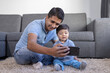 © Teran - Mexican father and child doing video call at home, father's day