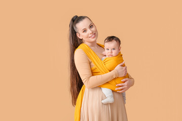 Canvas Print - Young mother with little baby in sling on light background