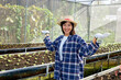 © JuYochi - The owner of the vegetable farm is happy with the product in the nursery.
