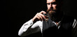© Yevhen - Attractive man with a whiskey. Handsome bearded man with stylish hair mustache and beard drinking brandy or whiskey from glass
