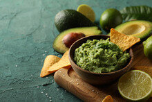 Concept Of Tasty Eating With Bowl Of Guacamole On Green Textured Background