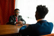 © Alexandr - two handsome african men in suits indoors