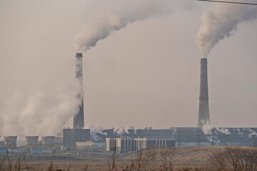 Almaty, Kazakhstan - 02.04.2021 : Territory and building of the heating plant with smoking pipes