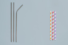 Steel and paper drinking straws on grey background