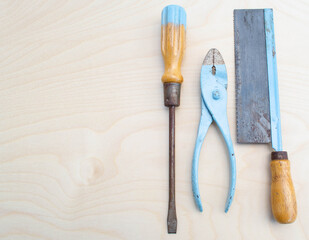 Old fashioned kids tools on wood background
