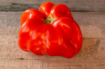 Close-up of fresh ripe tomato on wooden background