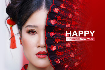 Happy chinese new year day. Close up face of a chinese girl and Chinese fan