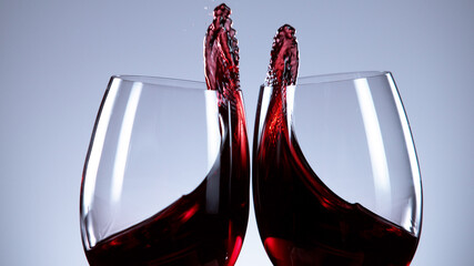 Two glasses of red wine hitting each other