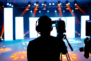 Professional cameraman - covering on event with a video, cameraman silhouette on live studio news, Selective focus