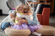 © luckybusiness - Little daughters in a hug with Mom and Dad while playing at home together. Family, home, togetherness