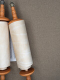 Fototapeta  - Torah scrolls written on parchment against a linen canvas background.copy space