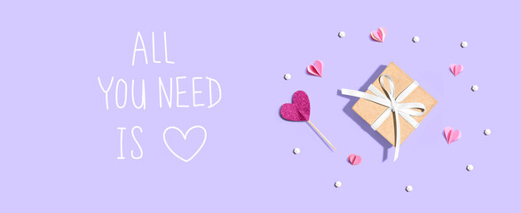 All you need is love message with a small gift box and paper hearts