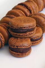 Homemade Chocolate cocoa macaron cookies on a white platter