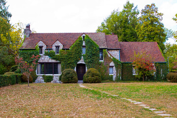 Wall Mural - Beautiful stone home covered with greenery.