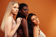 © iordani - young pretty caucasian, afro, scandinavian woman posing cheerful together on brown background, lifestyle diverse nationality people concept