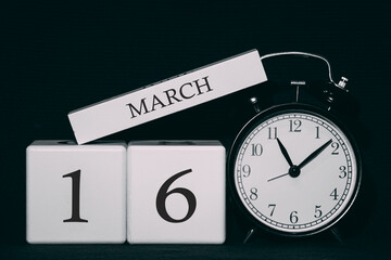 Important date and event on a black and white calendar. Cube date and month, day 16 March. Spring season.