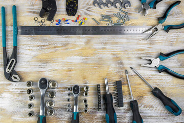 Locksmith tools pliers, wire cutters. pliers and round heads on a wooden background. Locksmith's tool. View from above. 