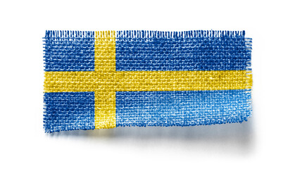 Sweden flag on a piece of cloth on a white background